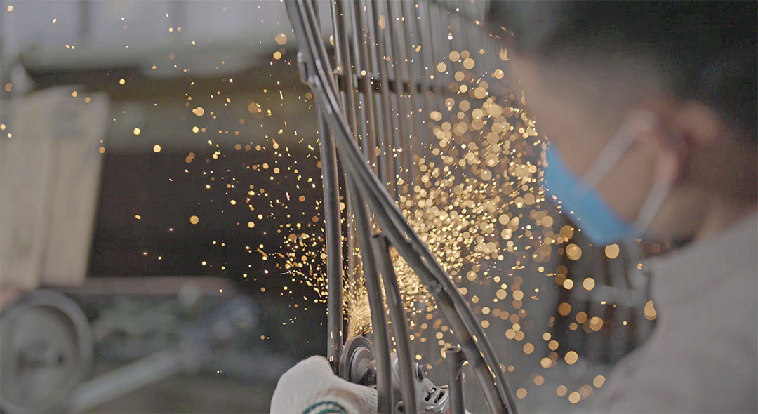 Grinding a metal frame in the Gainsville hardware workshop
